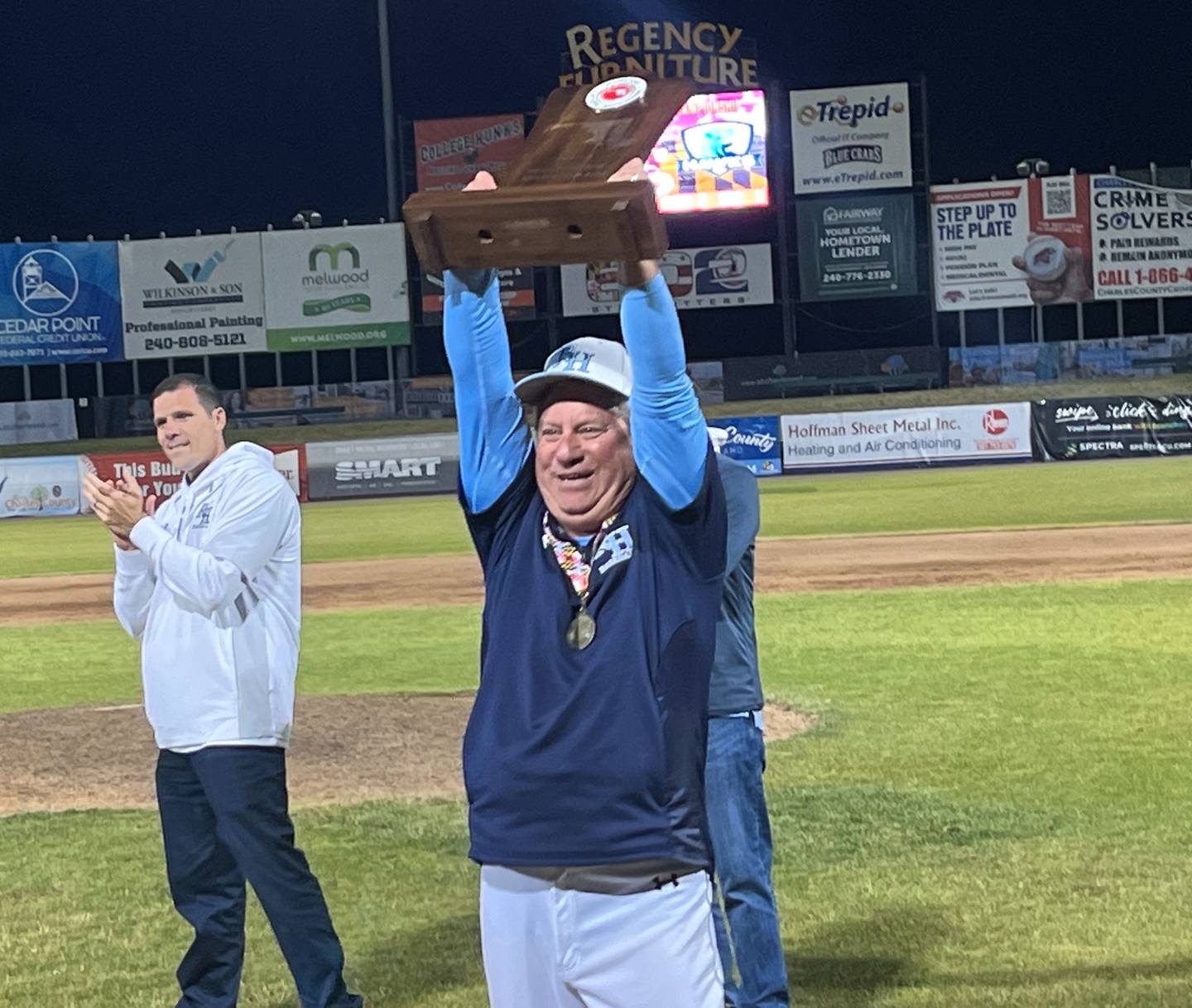 River Hill baseball coach Craig Estrin holds up the Class 3A state championship trophy Saturday evening. The No. 3 Hawks won their first title since 2009 with a 1-0 win over 15th-ranked C. Milton Wright at Regency Furniture Stadium in Southern Maryland.