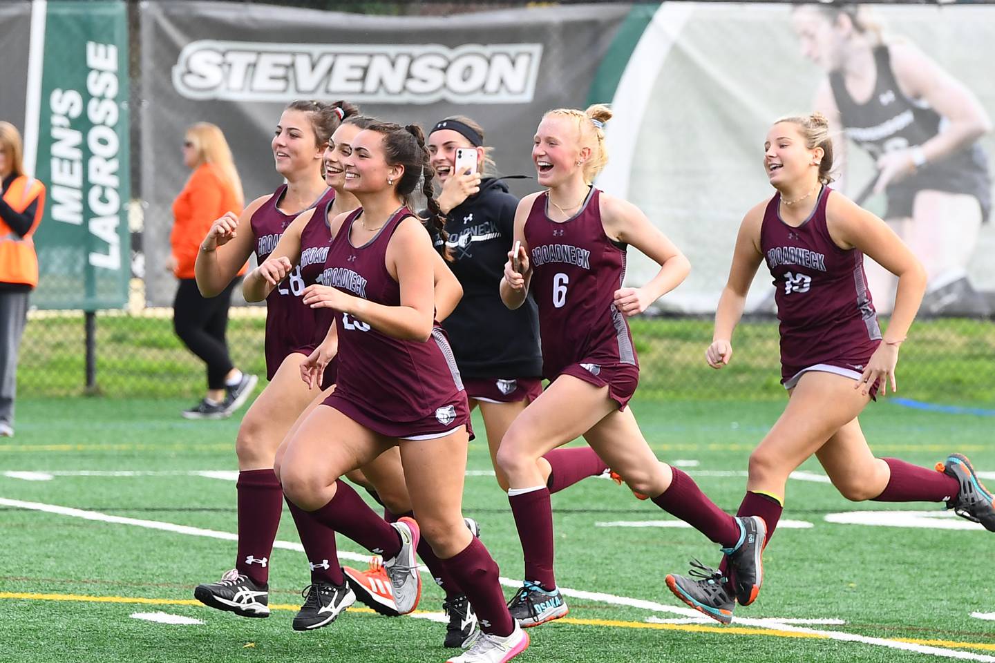 Broadneck players rush onto the field at Stevenson University to celebrate their first field hockey state title in 20 years.