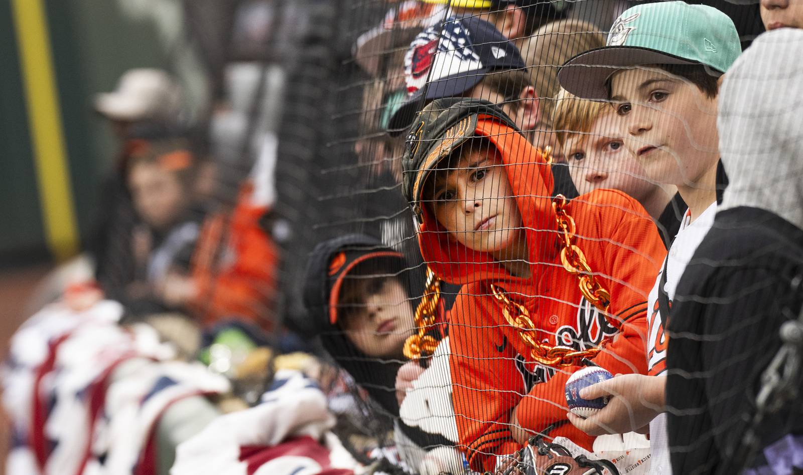 Jax Caruso, Luca Shekett, Simon Hoffberger, Zach Levinson, and Atticus Sentman, wait for an Orioles player to sign their baseballs and baseball gloves on Opening Day at Camden Yards on March 28, 2024.
