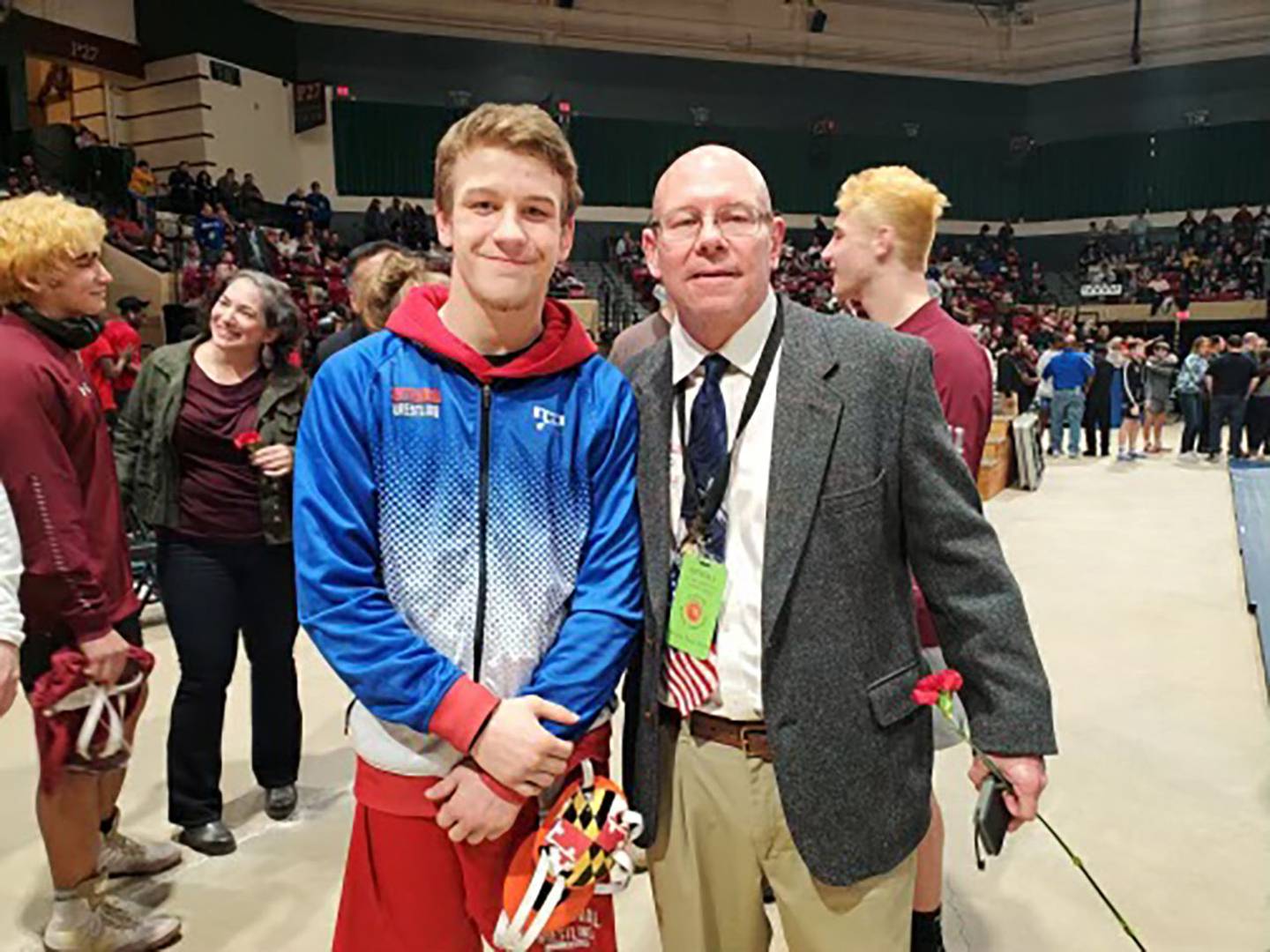 Centennial sophomore Calvin Kraisser (left) with his coach and father Cliff (right) earned his second Class 4A-3A state title at 138 pounds on Saturday at The Show Place Arena in Upper Marlboro.