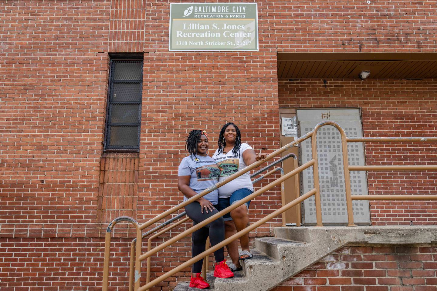 Eri Whitney Young, left, and Tracey Malone pose for a portrait on the steps in front of the Lillian S. Jones Recreation Center.