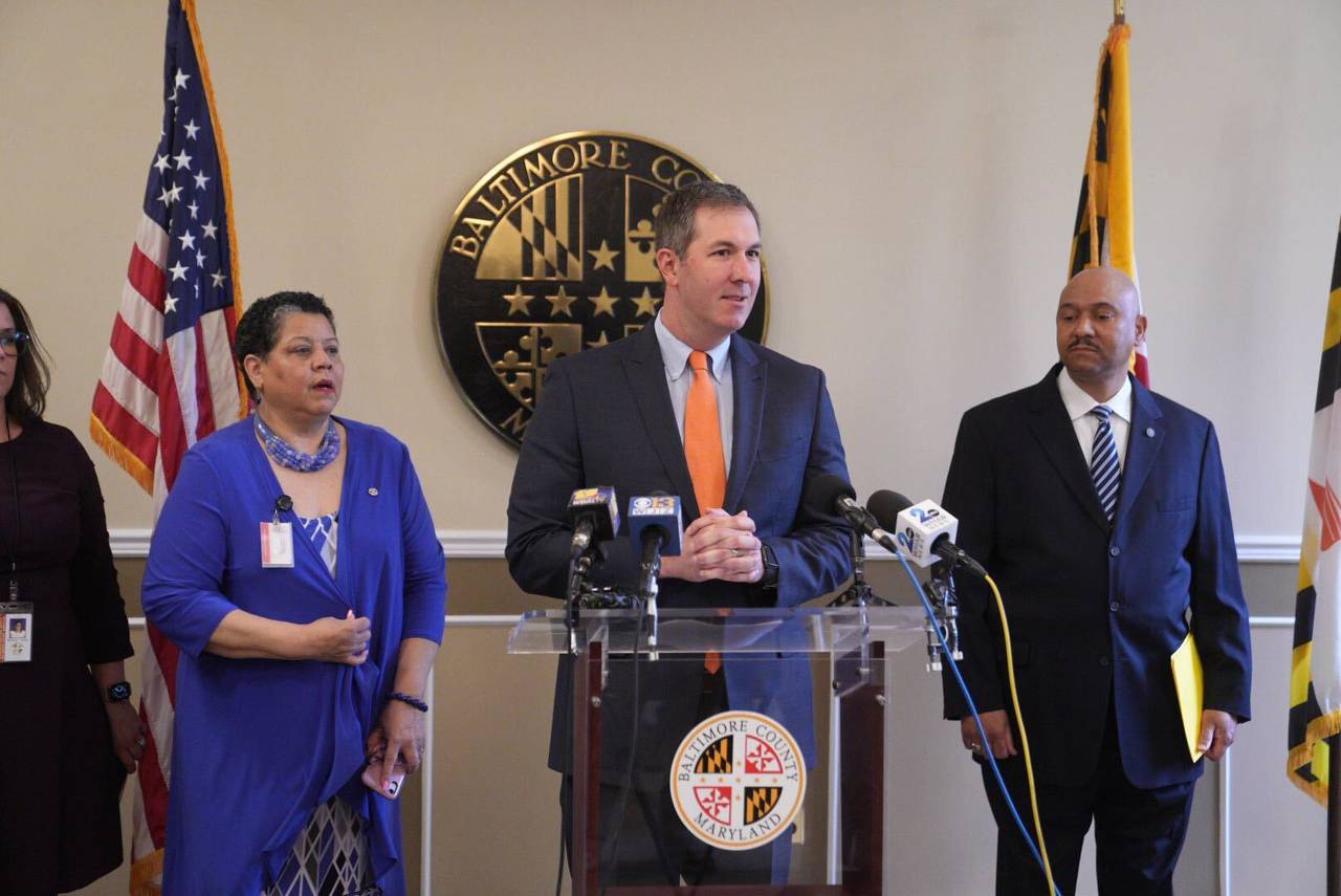 Baltimore County Executive John Olszewski announces his selection of Robert McCullough, right, as county police chief inside the Baltimore County Historic Courthouse in Towson, Friday, April 7, 2023. Administrative Officer Stacy Rodgers, left, listens to the county executive's remarks.
