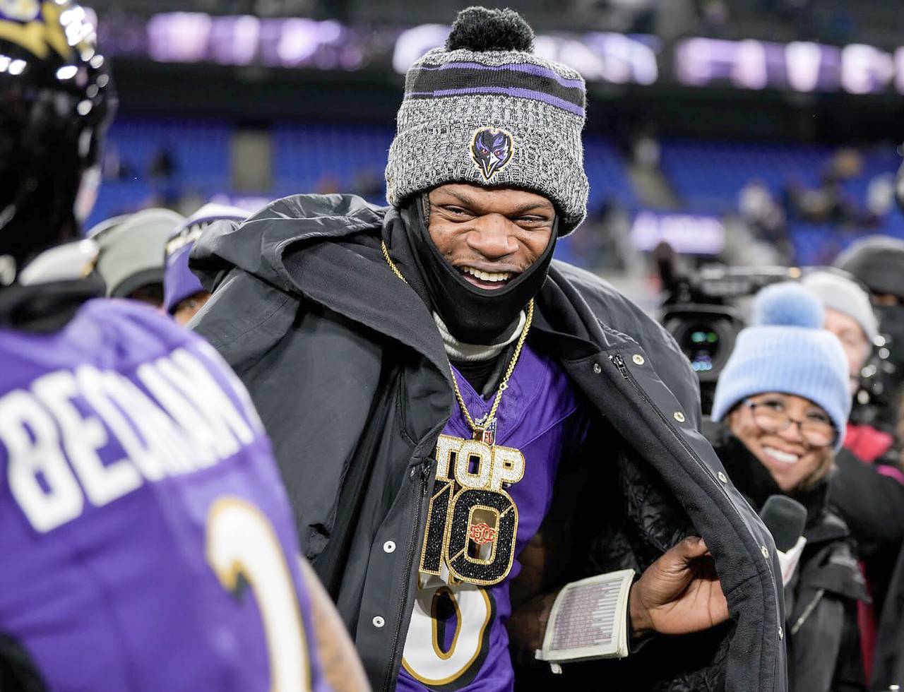 Lamar smiles after OBJ put a “Top 10” necklace on him after the game.