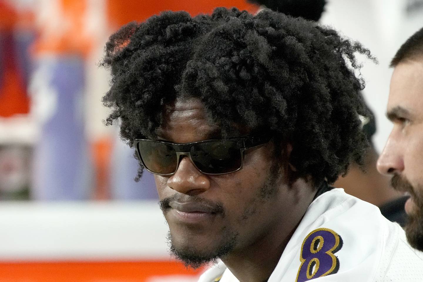 Baltimore Ravens quarterback Lamar Jackson watches from the bench during the first half of an NFL preseason football game against the Arizona Cardinals, Sunday, Aug. 21, 2022, in Glendale, Ariz. (AP Photo/Rick Scuteri)