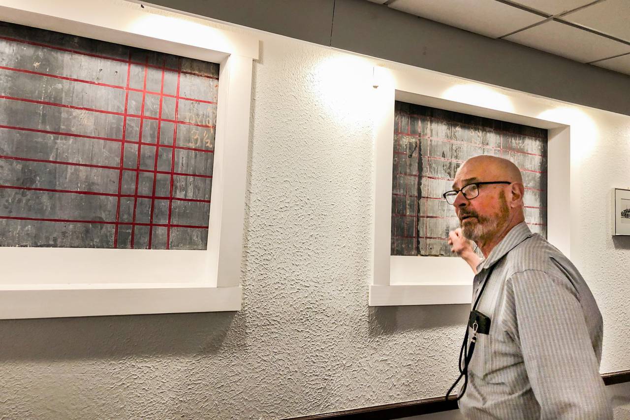 Squires Italian Restaurant owner Bob Romiti stands near a century-old blackboard that was used to post horse race results when Squires was a saloon in Dundalk on Friday, March 29, 2024. The space used to be his family’s apartment when he was a child.