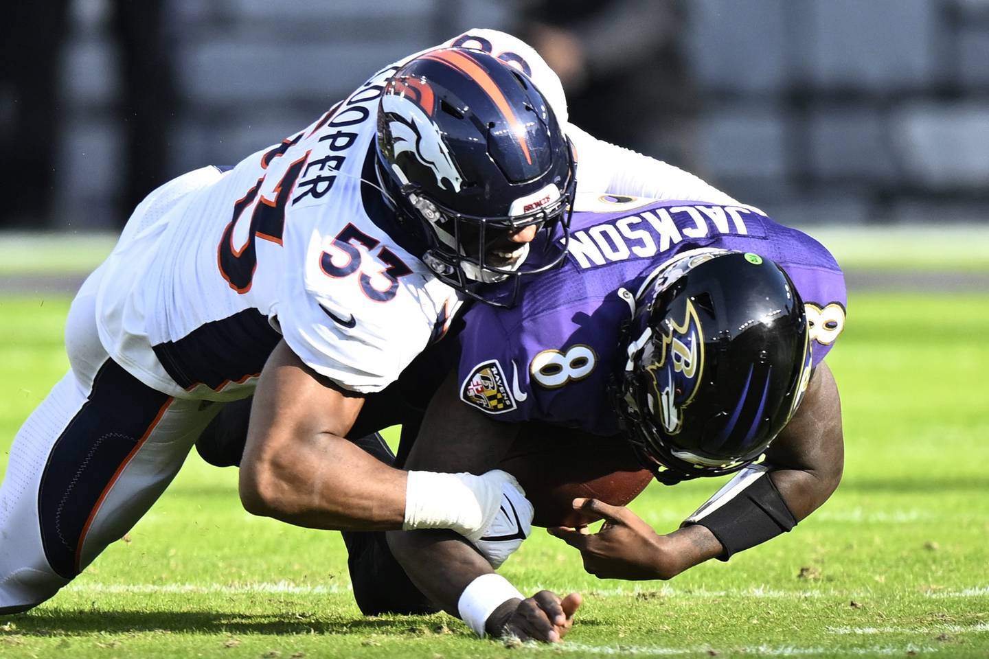 BALTIMORE, MARYLAND - DECEMBER 04: Jonathon Cooper #53 of the Denver Broncos sacks Lamar Jackson #8 of the Baltimore Ravens in the first half at M&T Bank Stadium on December 04, 2022 in Baltimore, Maryland.