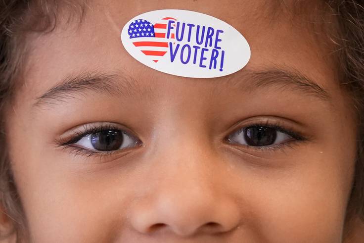 Keegan, 6, proudly displays his ”Future Voter“ sticker after his mom cast her vote on Election Day, Nov. 8, 2022, at Margaret Brent Elementary/Middle School. Polling locations for the general election remain open until 8 p.m.