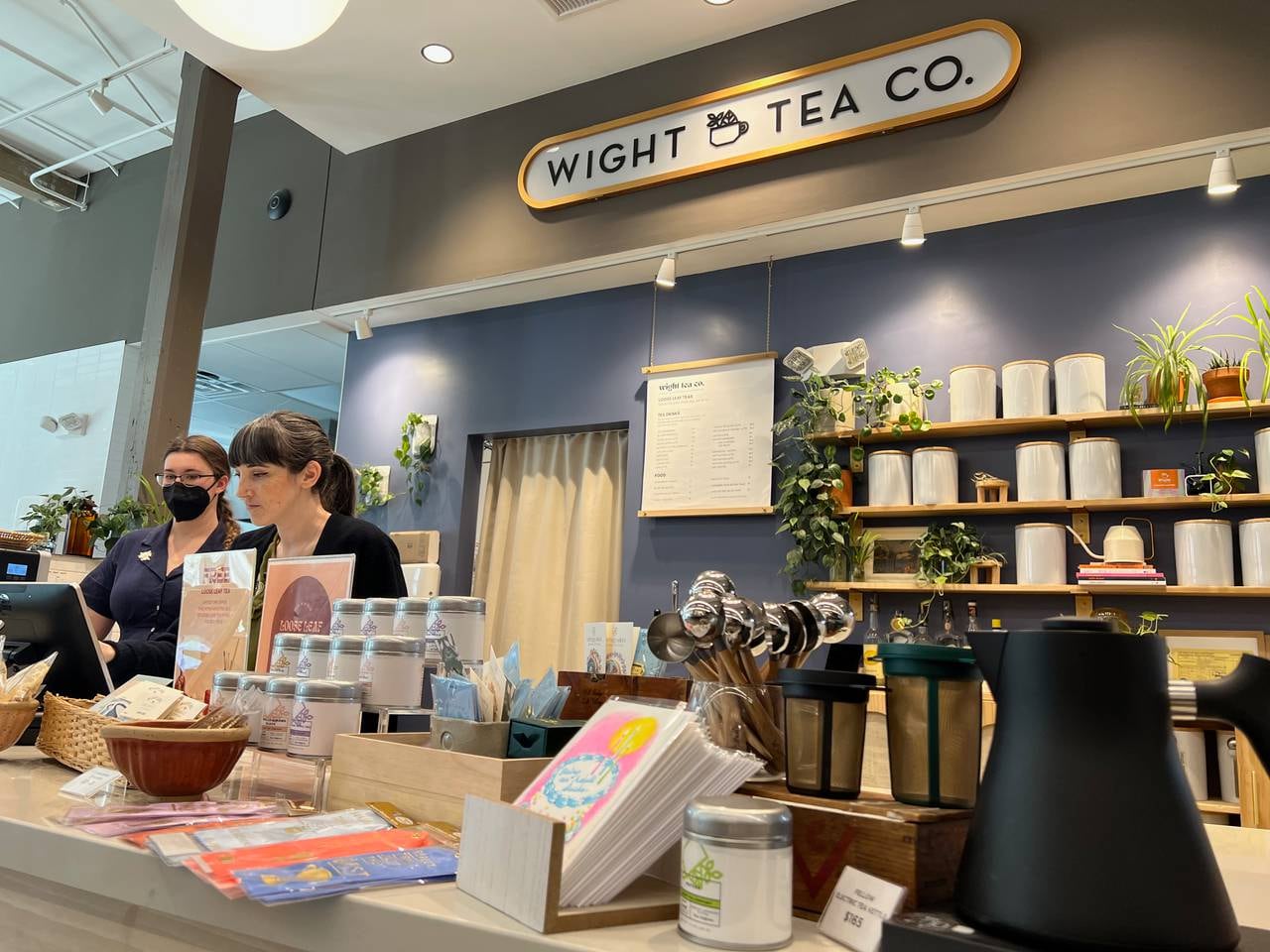 Brittany Wight and cashier Ariel complete an order at Wight Tea Co. in Whitehall Market on March 7, 2023.