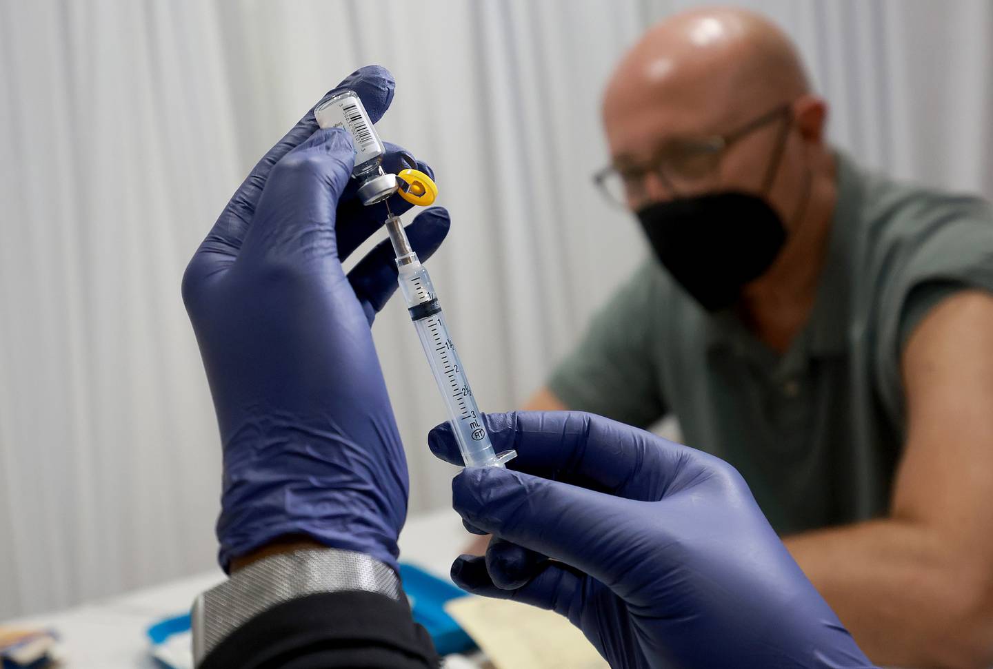A healthcare worker prepares to administer a vaccine to Michael Nicot for the prevention of monkeypox the Pride Center on July 12, 2022 in Wilton Manors, Florida. The center is offering the free smallpox/monkeypox vaccinations from the Florida Department of Health in Broward County as South Florida leads the state in the number of people infected.