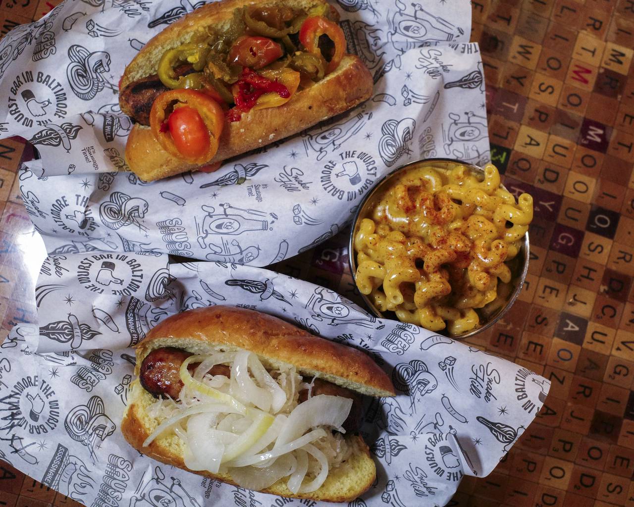 From left; Thai Chicken sausage with lemon grass, green chilis, and kaff, macaroni and cheese, and a Natty Boh bratwurst with sauerkraut, onions and spicy brown mustard.