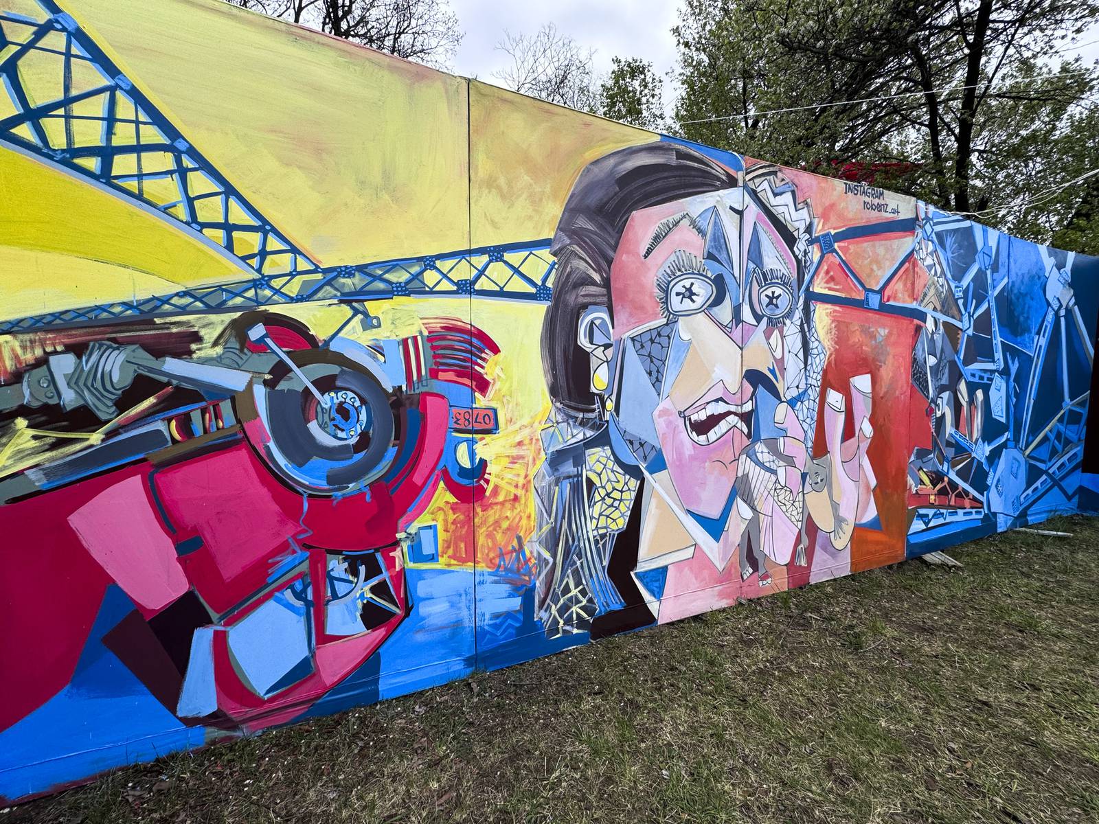 Roberto Marquez, an artist from Dallas, TX, painted a mural in their honor as well as painted their names on several crosses dotting the perimeter of flowers, candles, and othe mementos of remembrance. Members of the community honored the victims through prayer and song on April 6, 2024.