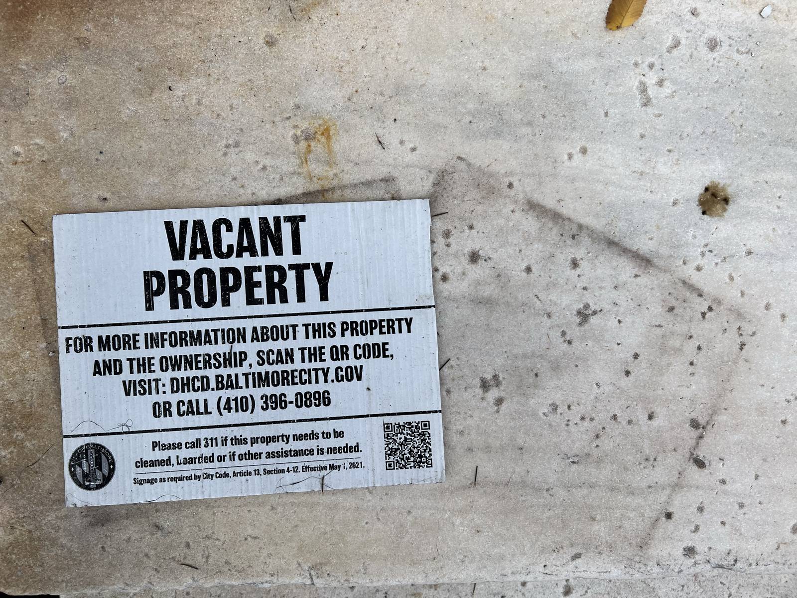 A vacant property notice sits on the marble steps of a West Baltimore home located in the Penn-North neighborhood and owned by an ABC Capital investor.