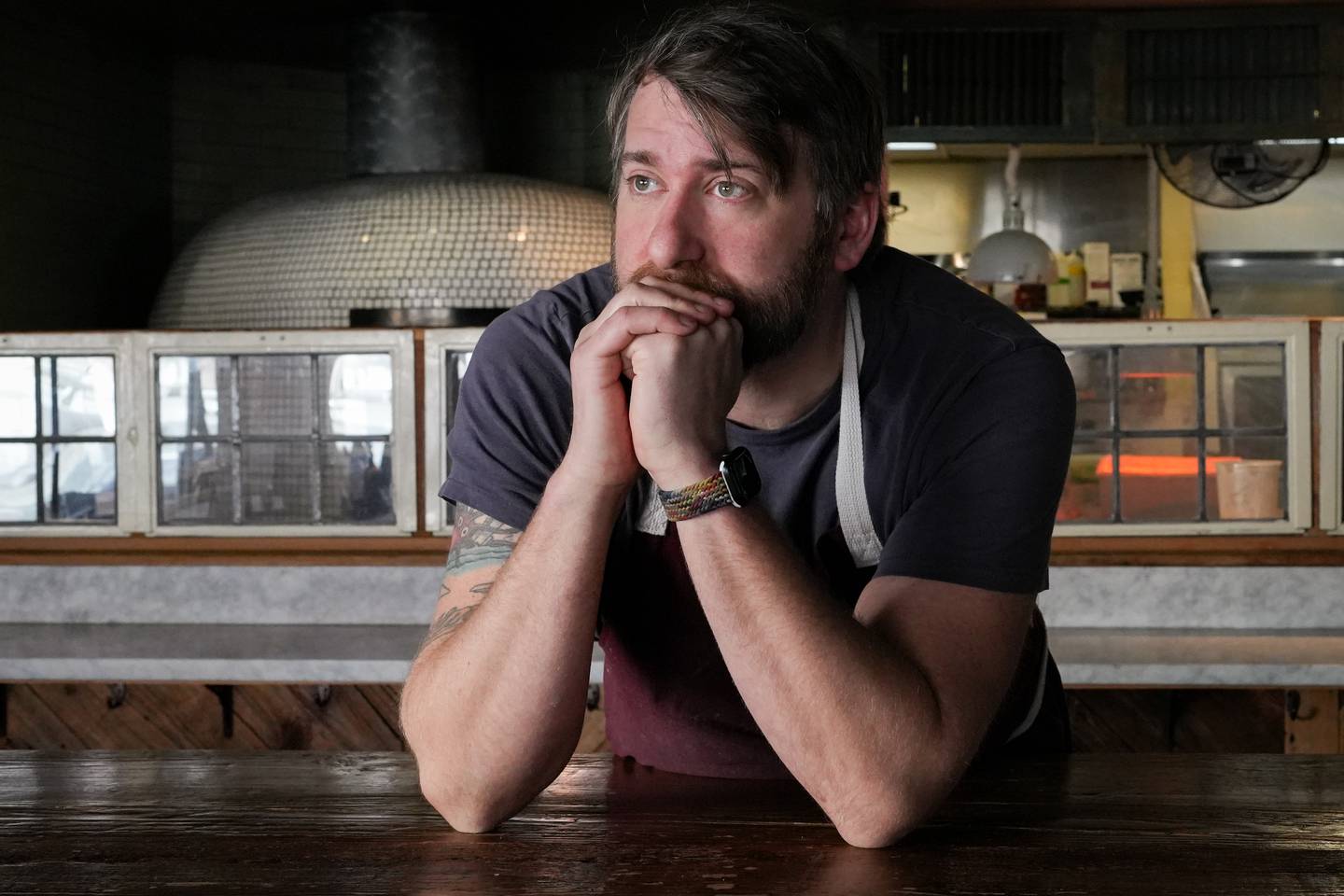 Ricky Johnson, owner and chef at Forno Restaurant and Wine Bar, stands for a portrait inside his restaurant on Monday, March 21. Johnson is one of several property and business owners who say they have concerns about the low levels of foot traffic in the district, which they need to stay in business.
