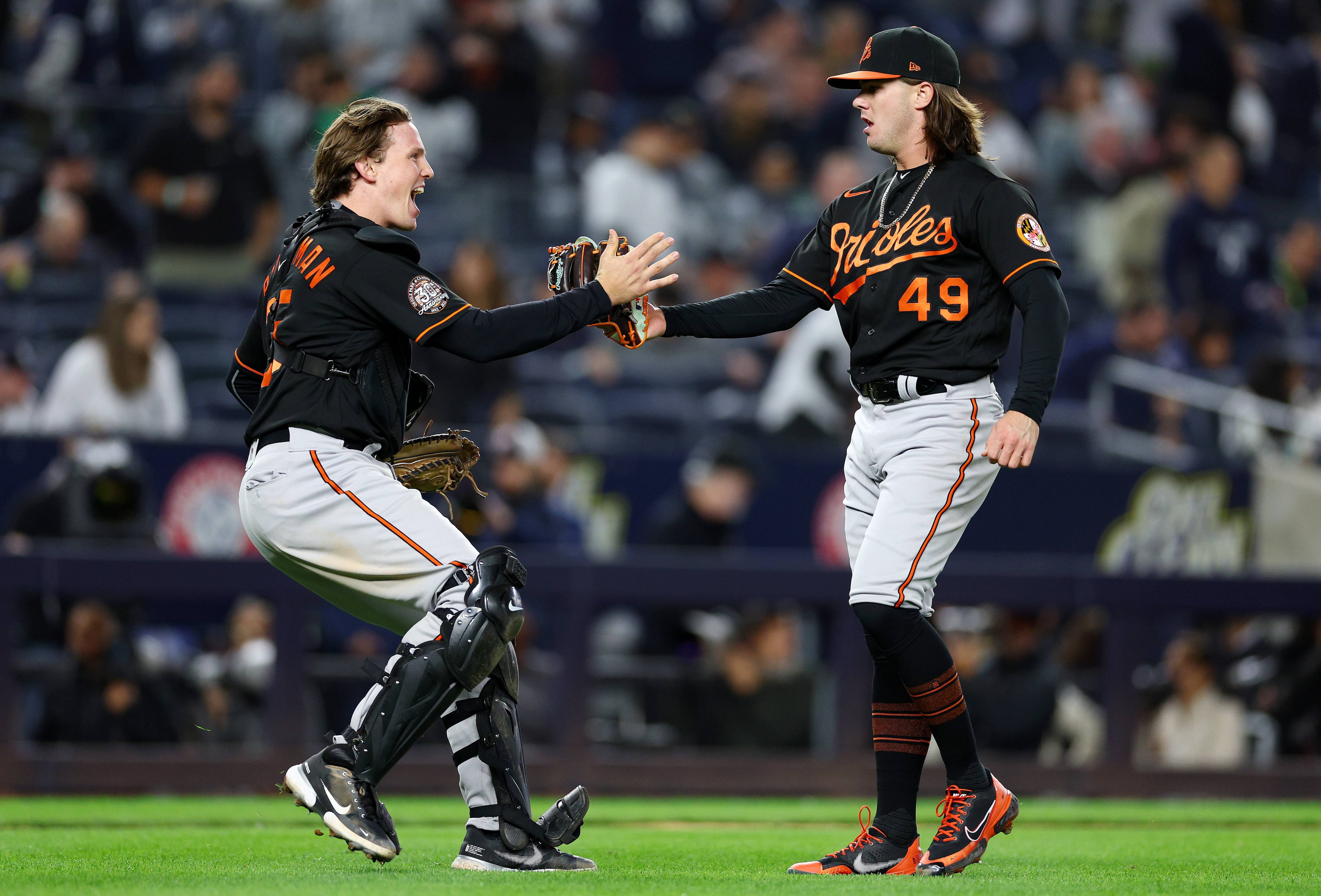 NEW YORK, NEW YORK - SEPTEMBER 30:  Adley Rutschman #35 and DL Hall #49 of the Baltimore Orioles celebrate the win over the New York Yankees at Yankee Stadium on September 30, 2022 in the Bronx borough of New York City. The Baltimore Orioles defeated the New York Yankees 2-1.