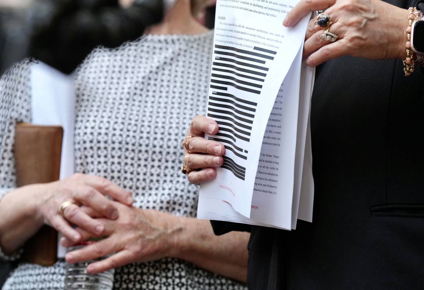 The Attorney General’s office released the Catholic Church Investigation papers.  Jean Hargadon (glasses) Teresa Lancaster,  holds a redacted copy of the release.