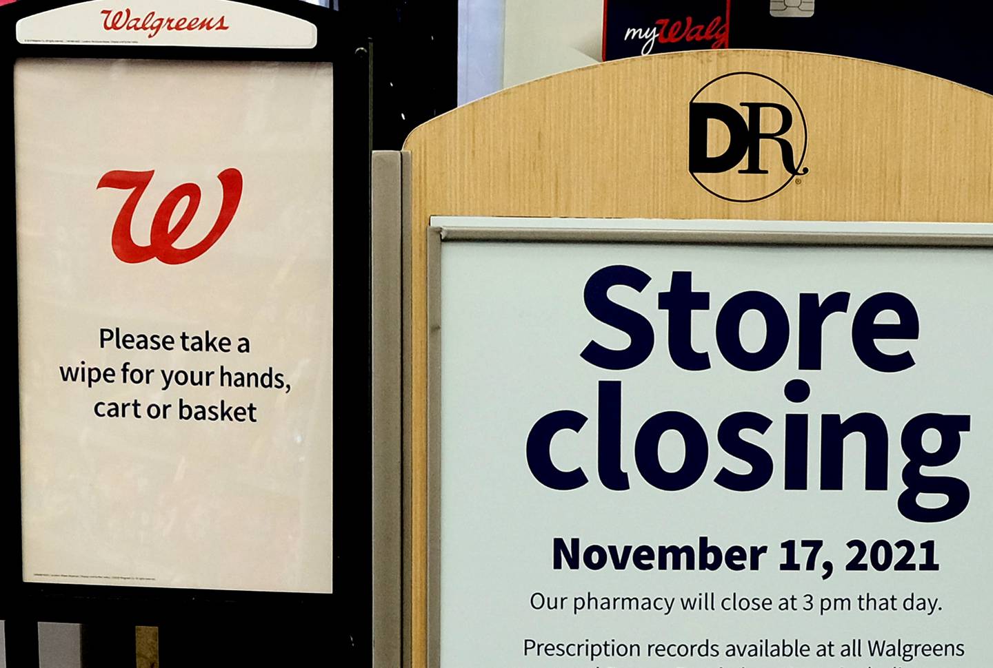 A sign informs customers that a pharmacy and convenience store is closing shortly on October 26, 2021 With empty shelves, regionally closed stores and increased security have greeted shoppers at many stores.