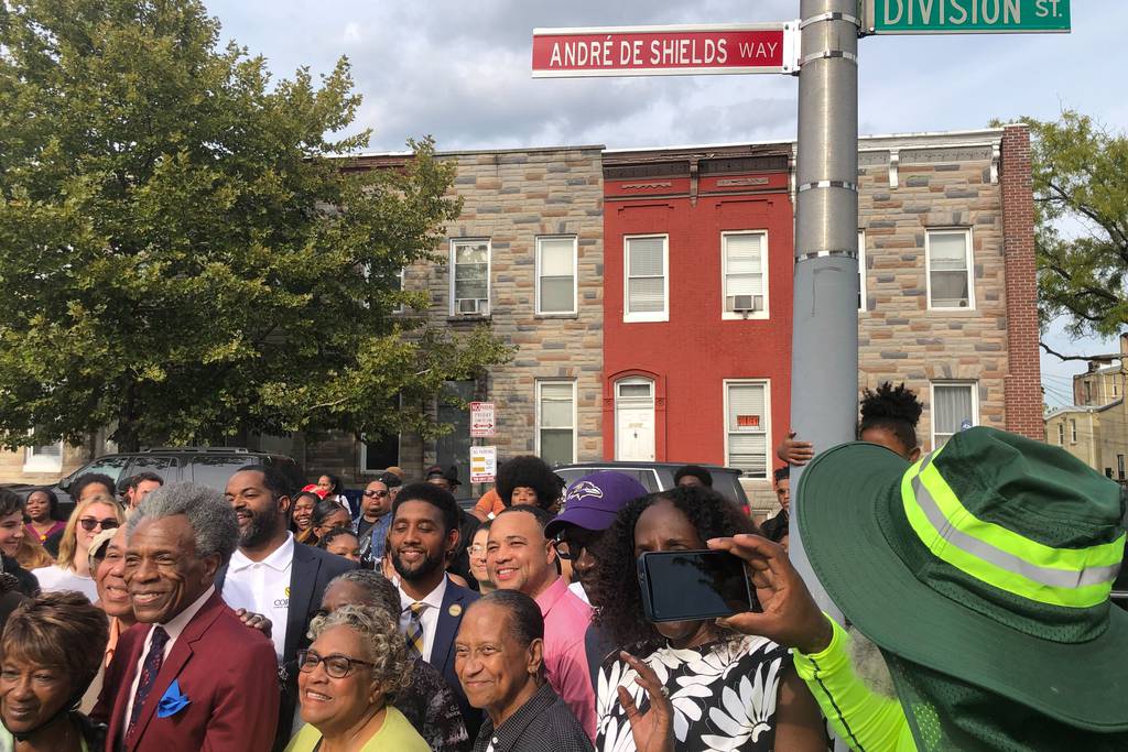 Andre De Shields, dressed in a slim cut crimson suit, was in Baltimore Thursday as the 1800 block of Division Street in the Upton neighborhood where he grew up, was renamed in his honor.