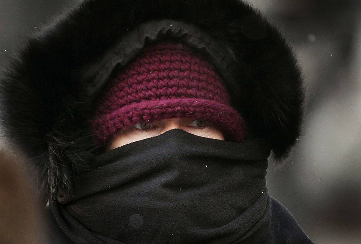 CHICAGO, IL - DECEMBER 13:  A commuter makes her way through downtown as temperatures hovered in the single digits during the morning rush hour December 13, 2010 in Chicago, Illinois. With wind gusts up to 40 miles per hour the wind chill temperatures in the city have been around -10 degrees.