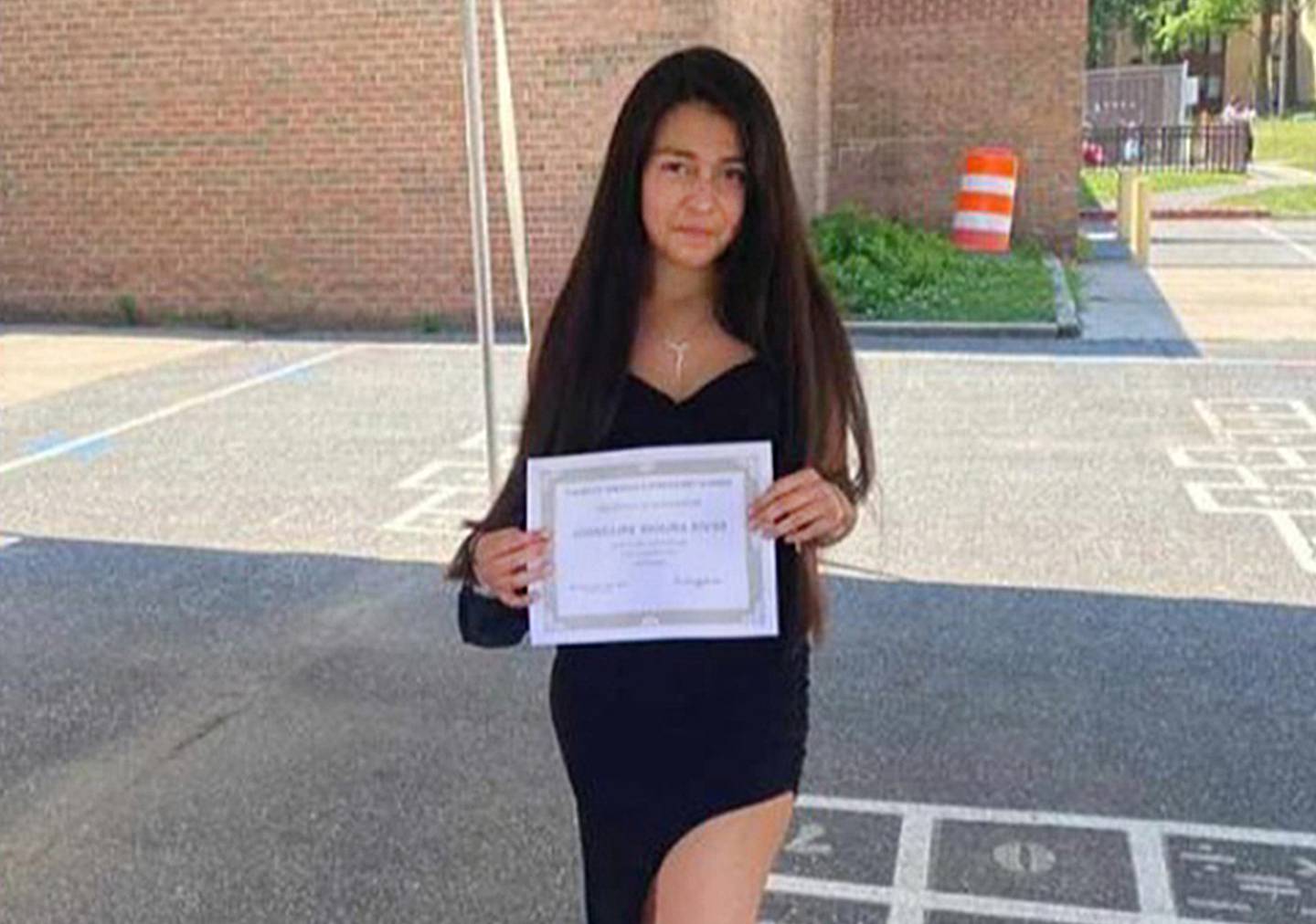 Josselina Maritza Molina Rivas holds her diploma.