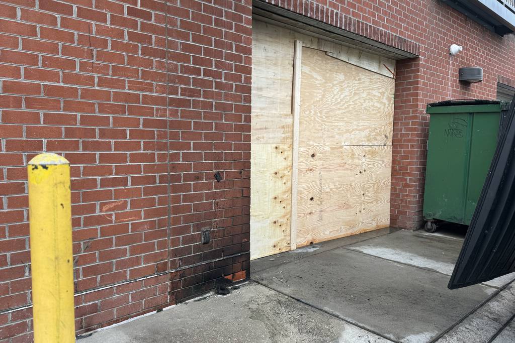 The exterior of Papi Cuisine was mostly cleaned up by early Monday evening after a fire outside its back door.