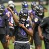 Baltimore Ravens quarterback Lamar Jackson, center, works out during organized team activities Wednesday, May 24, 2023 in Owings Mills.
