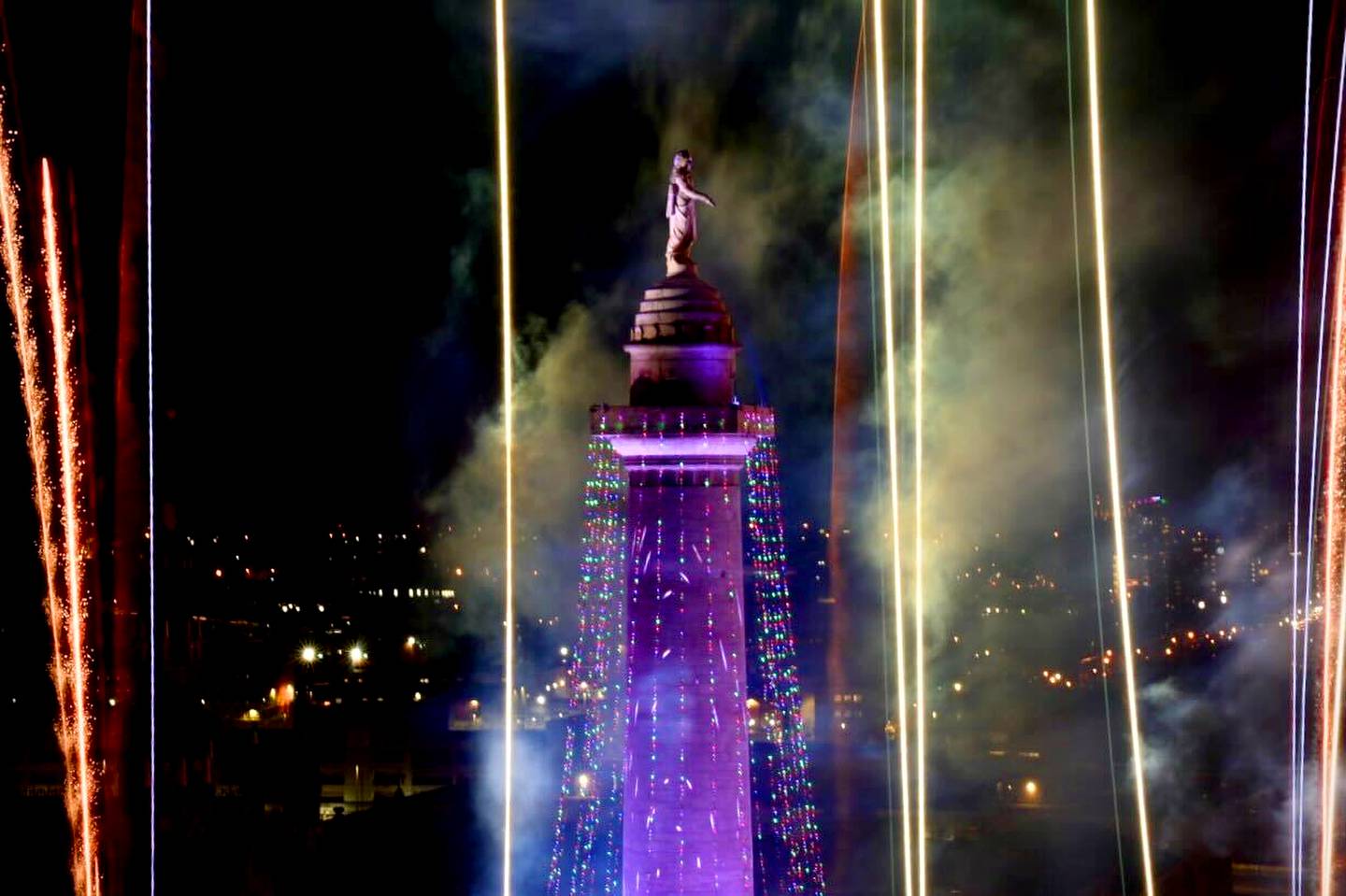 Fireworks ignite the sky at the 51st Monument Lighting in Mount Vernon Thursday night, kicking off the start of December’s holiday season, seen from Topside in hotel Revival in Baltimore.