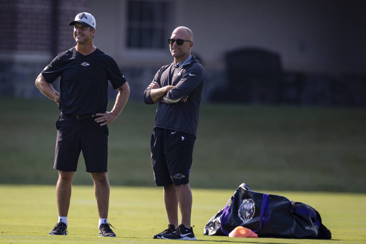 Head coach John Harbaugh and Executive Vice President and General Manager Eric DeCosta of the Baltimore Ravens watch play during training camp at Under Armour Performance Center Baltimore Ravens on July 28, 2021 in Owings Mills, Maryland.