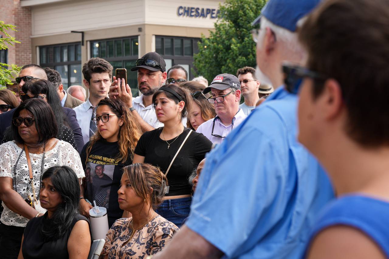 To the right, former Capital Gazette staffers watch as the audience reacts to Andrea Chamblee, widow of reporter John McNamara, speaking at a ceremony memorializing the victims in the 2018 Capital Gazette shooting on Wednesday, June 28, 2023 in downtown Annapolis. On this day five years ago, a gunman with a grudge against the Annapolis newspaper blasted his way into their newsroom, killing five staffers inside. He is serving numerous life sentences with no chance of parole.