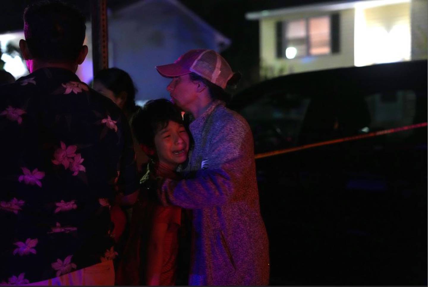 An adult comforts a distraught child at the scene of a shooting on Paddington Place in Annapolis that left one dead and three injured on Sunday, June 11, 2023.