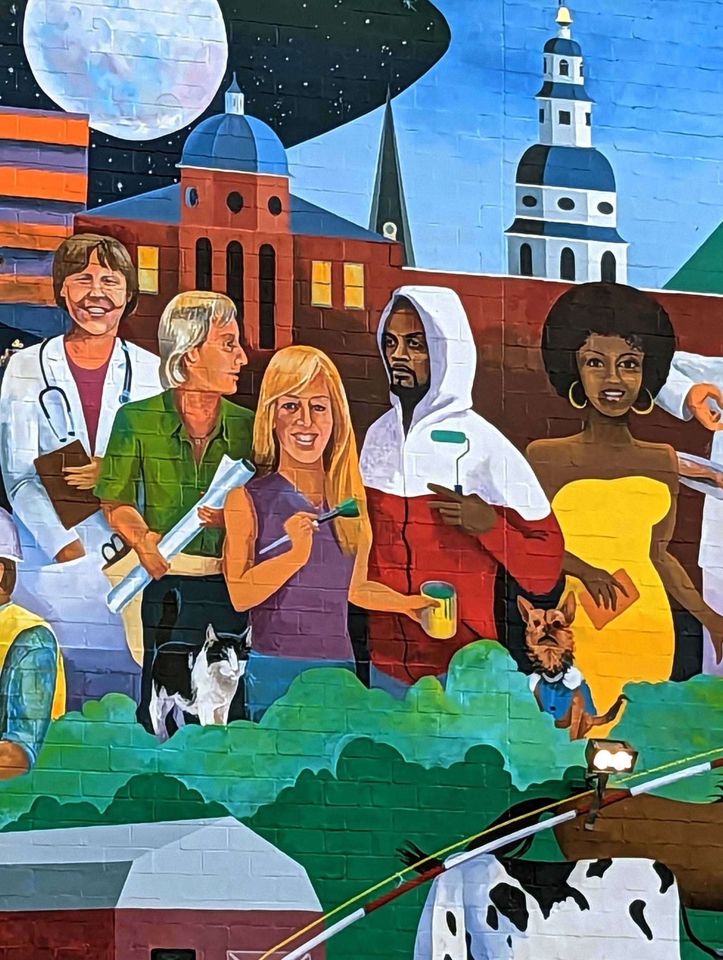 "The Best Place for All" on the side of the Arundel Center at 44 Calvert St. in Annapolis includes a self-portrait of the artists, Cindy Fletcher Holden and Comacell Brown.
