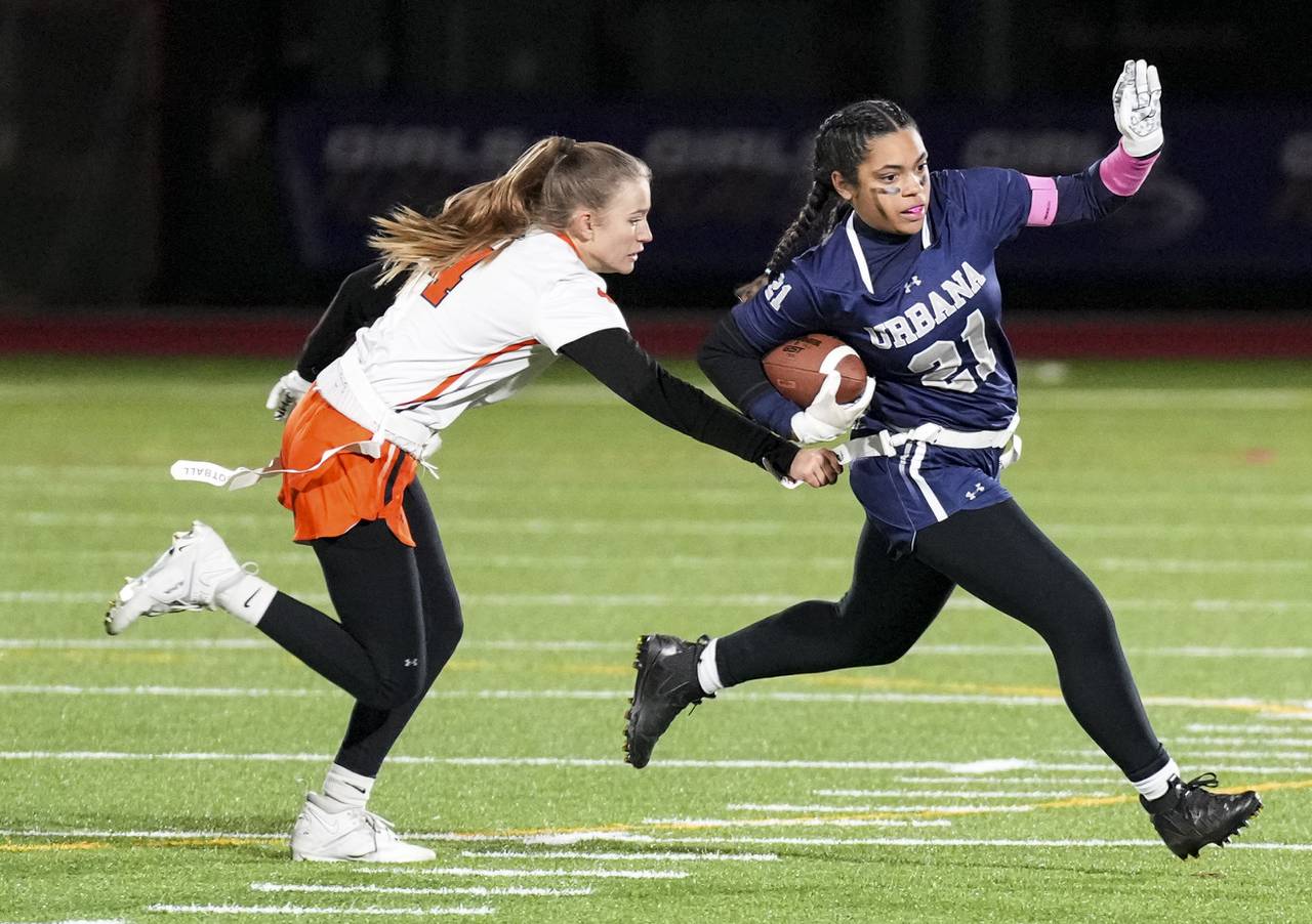 Urbana’s Keira Speaks (21) takes the ball down the field while attempting to avoid Middletown’s Genevieve Chase (4) during the Girls flag Championship at the Under Armour’s “The Stadium at the House” in Baltimore, Wednesday.