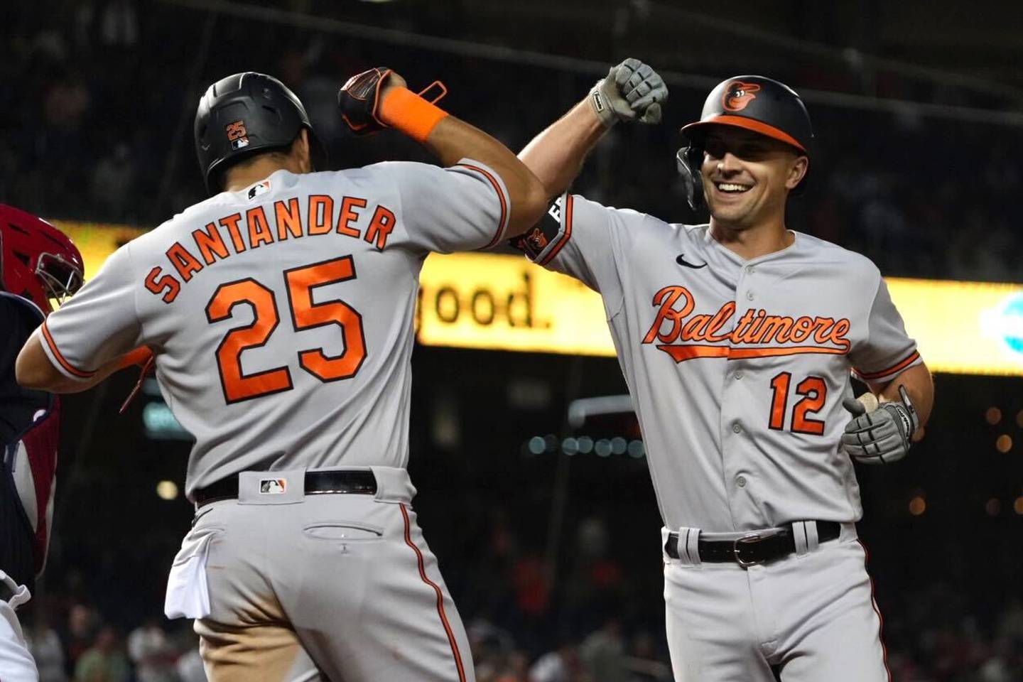 Orioles outfielder Anthony Santander celebrates with Adam Frazier after he scored a run in Baltimore's game against the Nationals at Nationals Park.