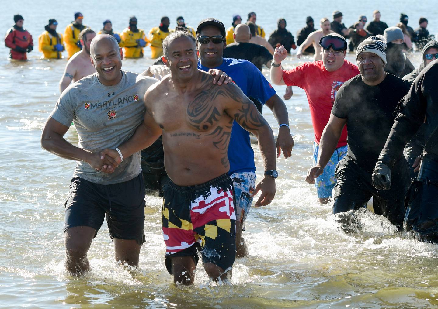 Gov. Wes Moore, from left, Delegate C.T. Wilson of Charles County, Special Olympics athlete Annu Singleton, of Baltimore, and Special Olympics athlete Adam Hays, of Frederick, participate in the Maryland State Police Polar Bear Plunge to benefit Special Olympics Maryland, Saturday, Feb. 4, 2023 at Sandy Point State Park in Annapolis.