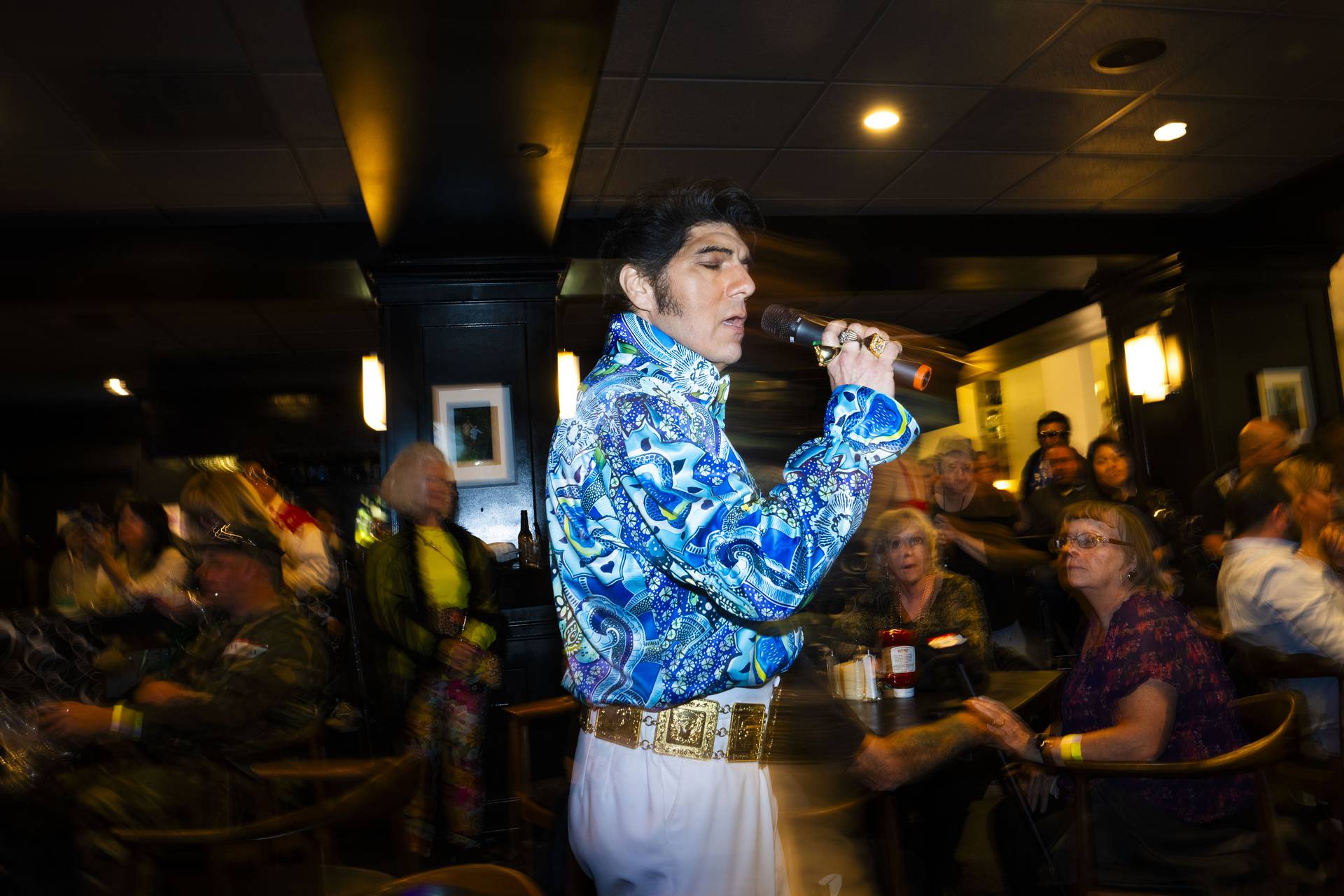 An Elvis fan wears his name around their neck during the performances