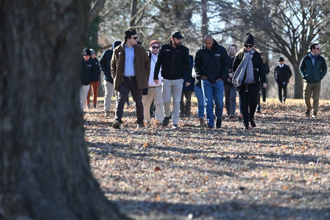 Gov. Wes Moore, second from right, listens to Maryland Natural Resources Secretary talk about Holly Beach Farm during a tour on Feb. 6, 2024. On Wednesday, March 13, Moore and the Board of Public Works approved taking ownership of the 300-acre site near Annapolis.