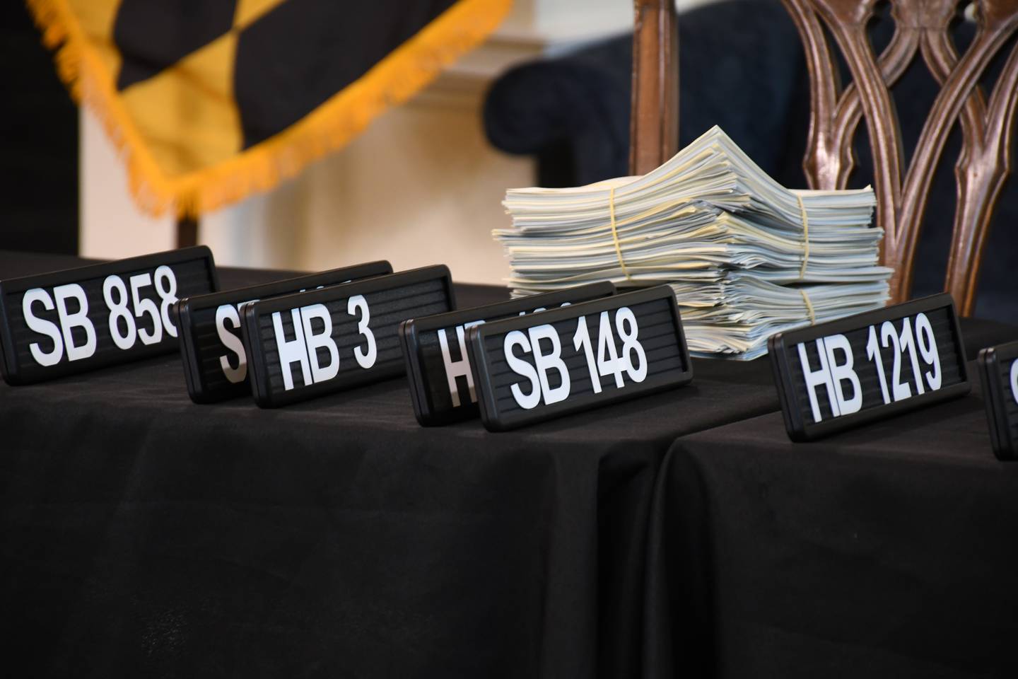 Paperwork and signs listing bill numbers are lined up for a bill signing ceremony at the State House in Annapolis on Tuesday, May 16, 2023.
