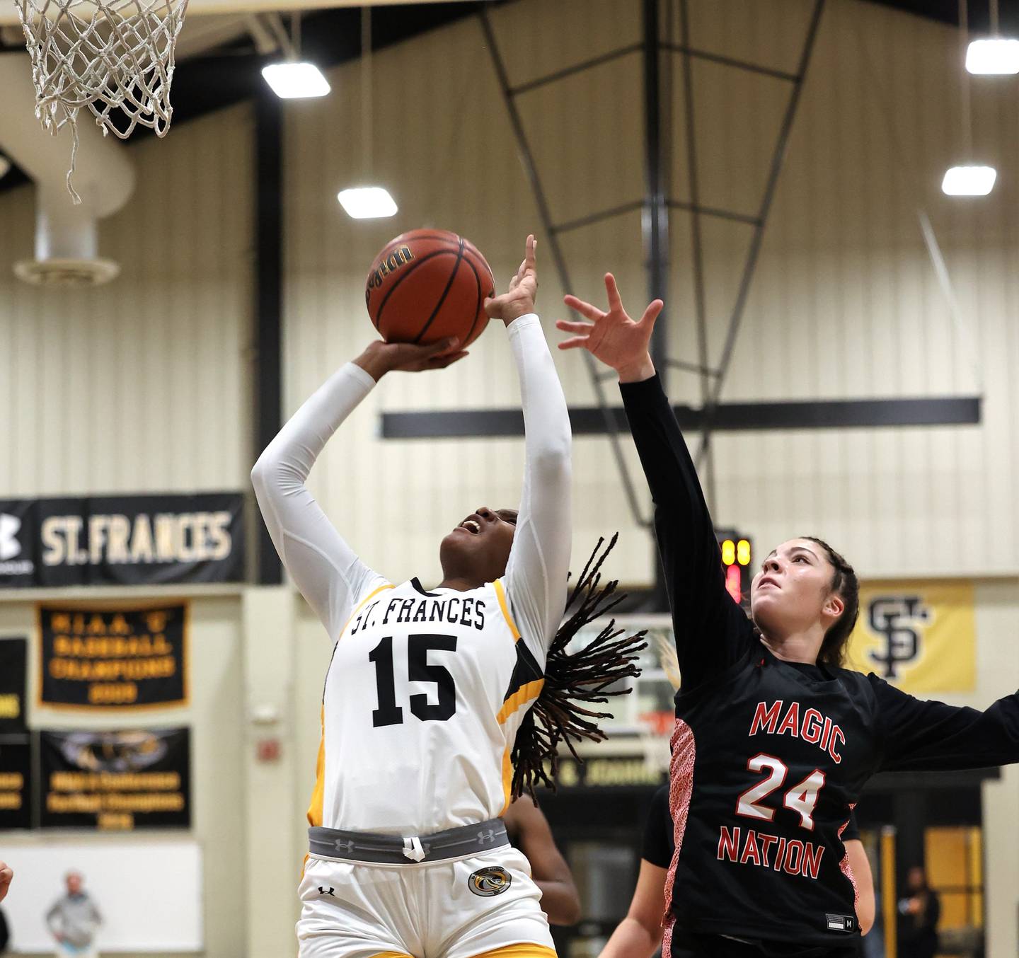 St. Frances' Ande'a Cherisier (15) puts up a shot as Mercy's Logan Jefferson defends during Wednedsay evening's IAAM A Conference girls basketball contest. Cherisier finished with 15 points as the No. 3 Panthers defeated eighth-ranked Mercy, 69-32, in their home opener in East Baltimore.
