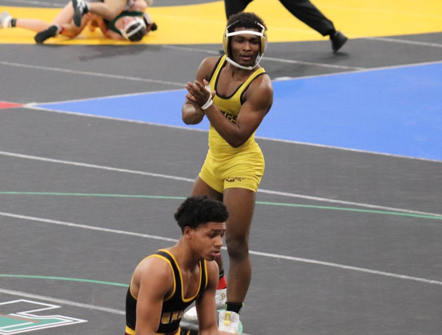Amondre Wooden (standing) gained revenge with a 5-1 decision over Dunbar's Cameron Deville (kneeling) to earn third place at the Class 2A-1A state tournament as a 132-pound freshman a week after having lost to Deville, 13-5, in their Class 2A-1A North Regional title bout.