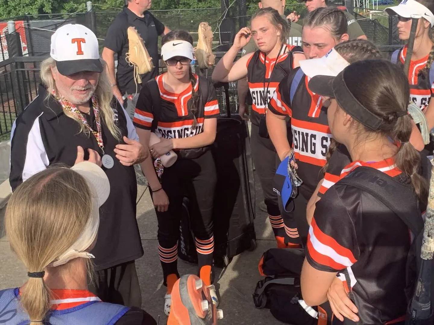 Rising Sun coach Paul Taylor (left) talks to his team after last year's Class 2A state softball championship game. The No. 6 Tigers claimed the UCBAC Chesapeake crown Monday with a 2-1 victory over 12th-ranked Patterson Mill in Harford County.