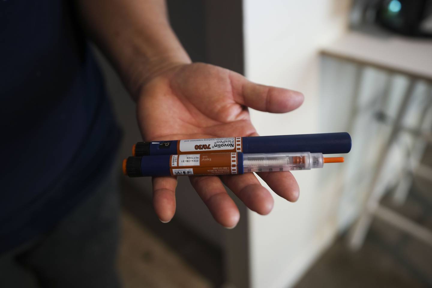 Verónica del Cid Gaitán, an undocumented immigrant, shows the insulin pens 
her husband requires. He cannot get a prescription for the medicine, so they purchase it 
from a friend. They cannot get a prescription for the medicine, so they purchase it in bulk 
with other families.  Gaitán is pictured here in her home on April 14, 2023.