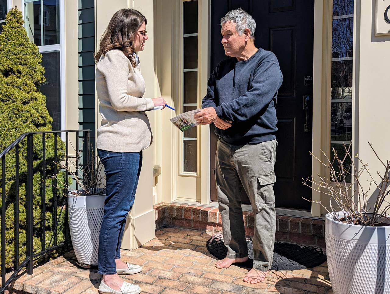State Sen. Sarah Elfreth, one of almost 20 Democratic candidates for Congress in the vacant 3rd District, talks with Hampton E. Brown III during a door-knocking swing through Ellicott City on March 24, 2024. She said she has knocked on 10,000 doors on weekends since announcing her campaign. She leaves campaign literature when no one is home. Once the General Assembly session ends in April, that pace will quicken.