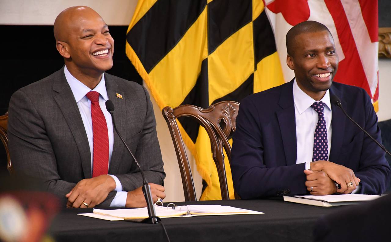Maryland Gov. Wes Moore, left, and his nominee for secretary of veterans affairs, Anthony Woods, listen during an event at the State House in Annapolis with military veterans.
