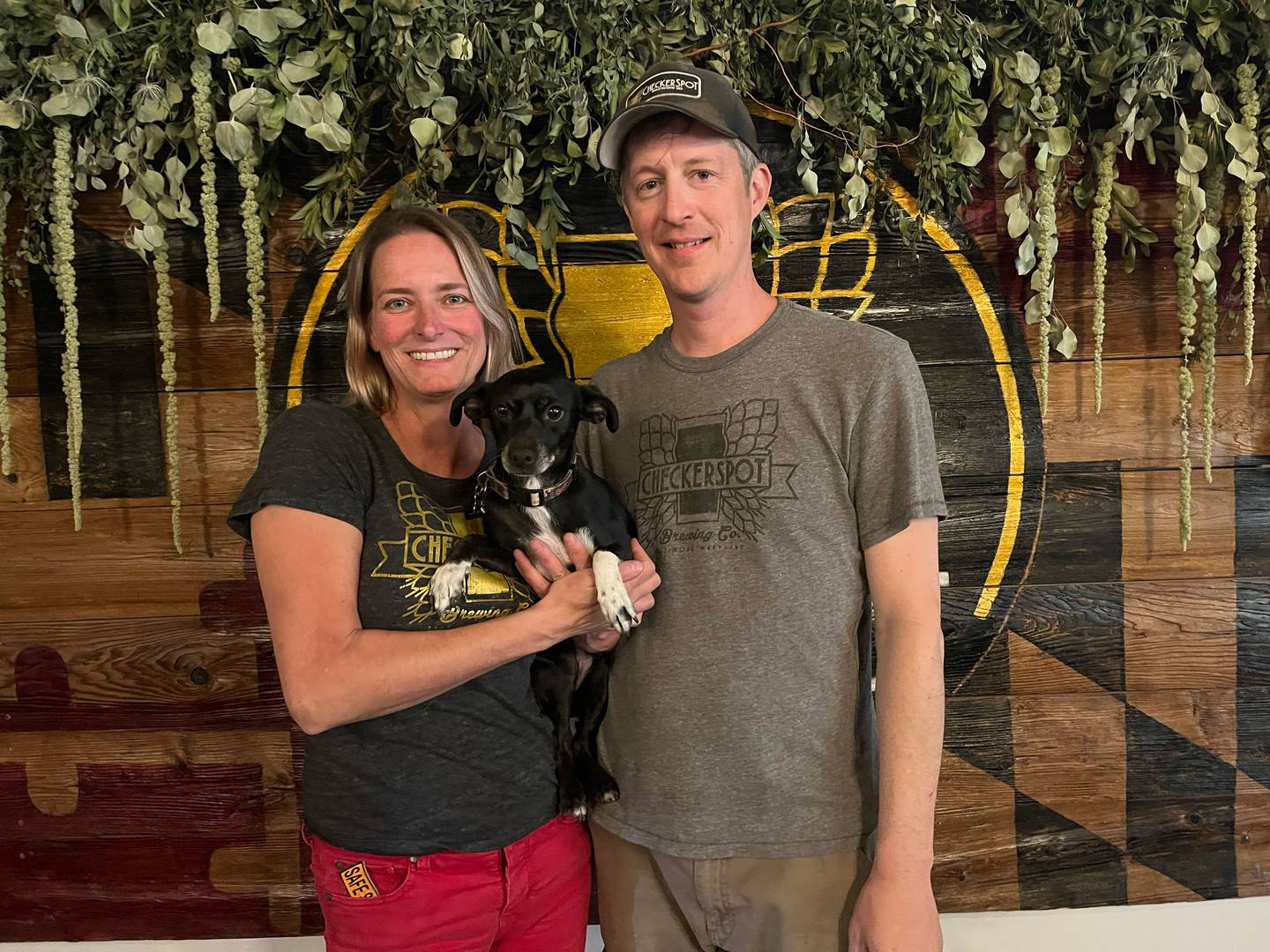 Checkerspot Brewing Company co-owners Judy and Rob Neff, and their dog, Dixie, in the taproom at Checkerspot.
