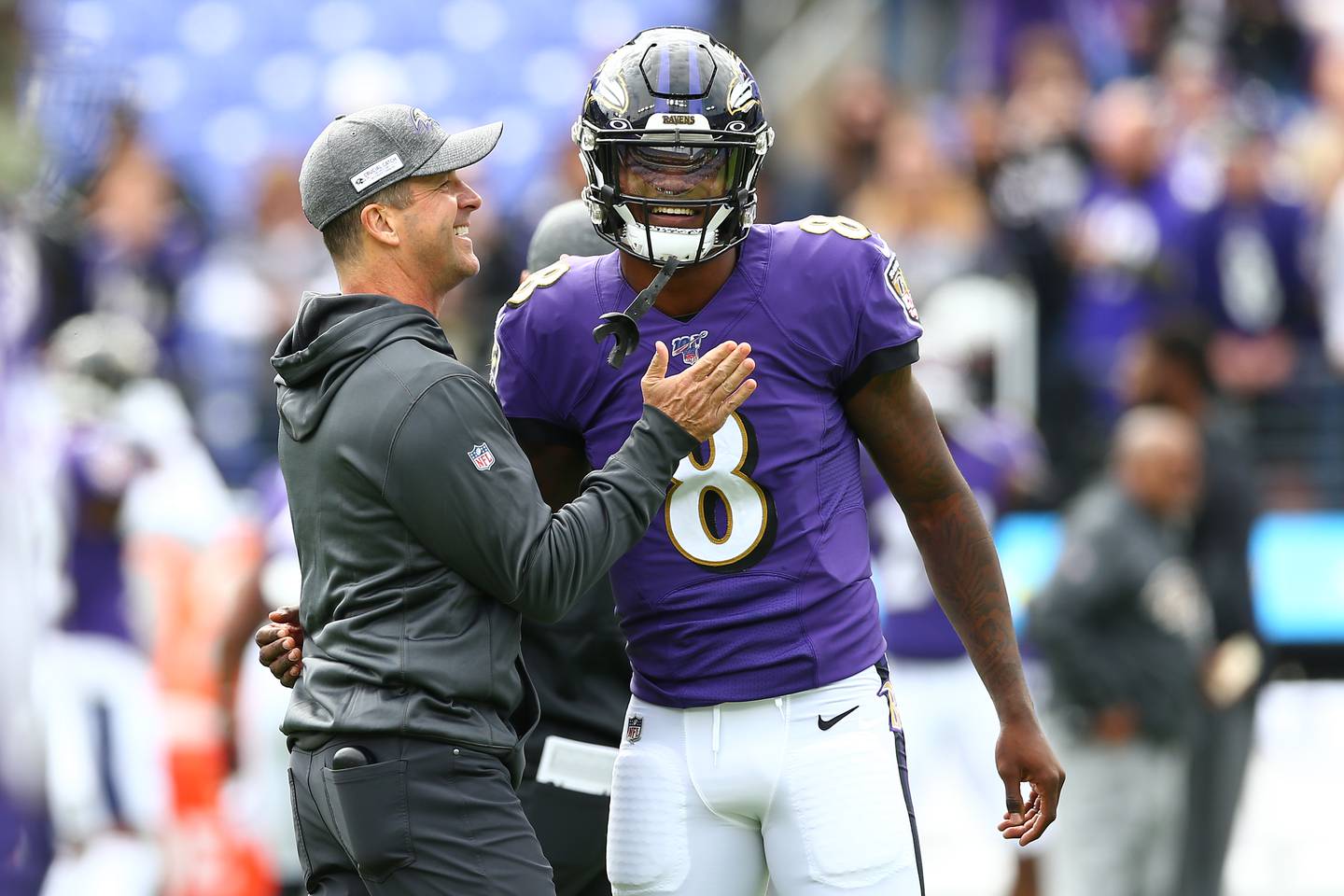 BALTIMORE, MD - OCTOBER 13: Head coach John Harbaugh interacts with Lamar Jackson #8 of the Baltimore Ravens prior to playing against the Cincinnati Bengals at M&T Bank Stadium on October 13, 2019 in Baltimore, Maryland.