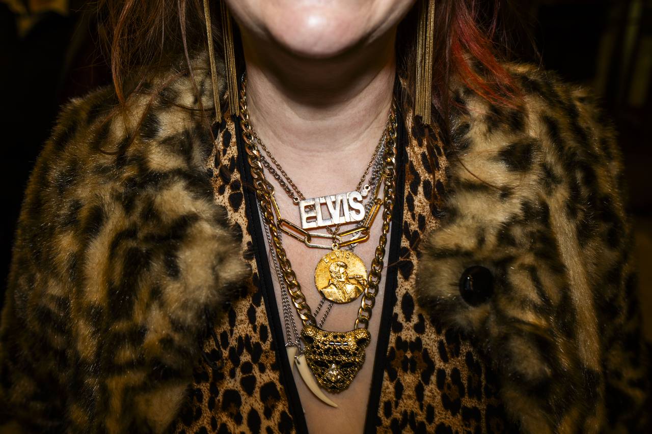 An Elvis fan wears his name around their neck during the performances