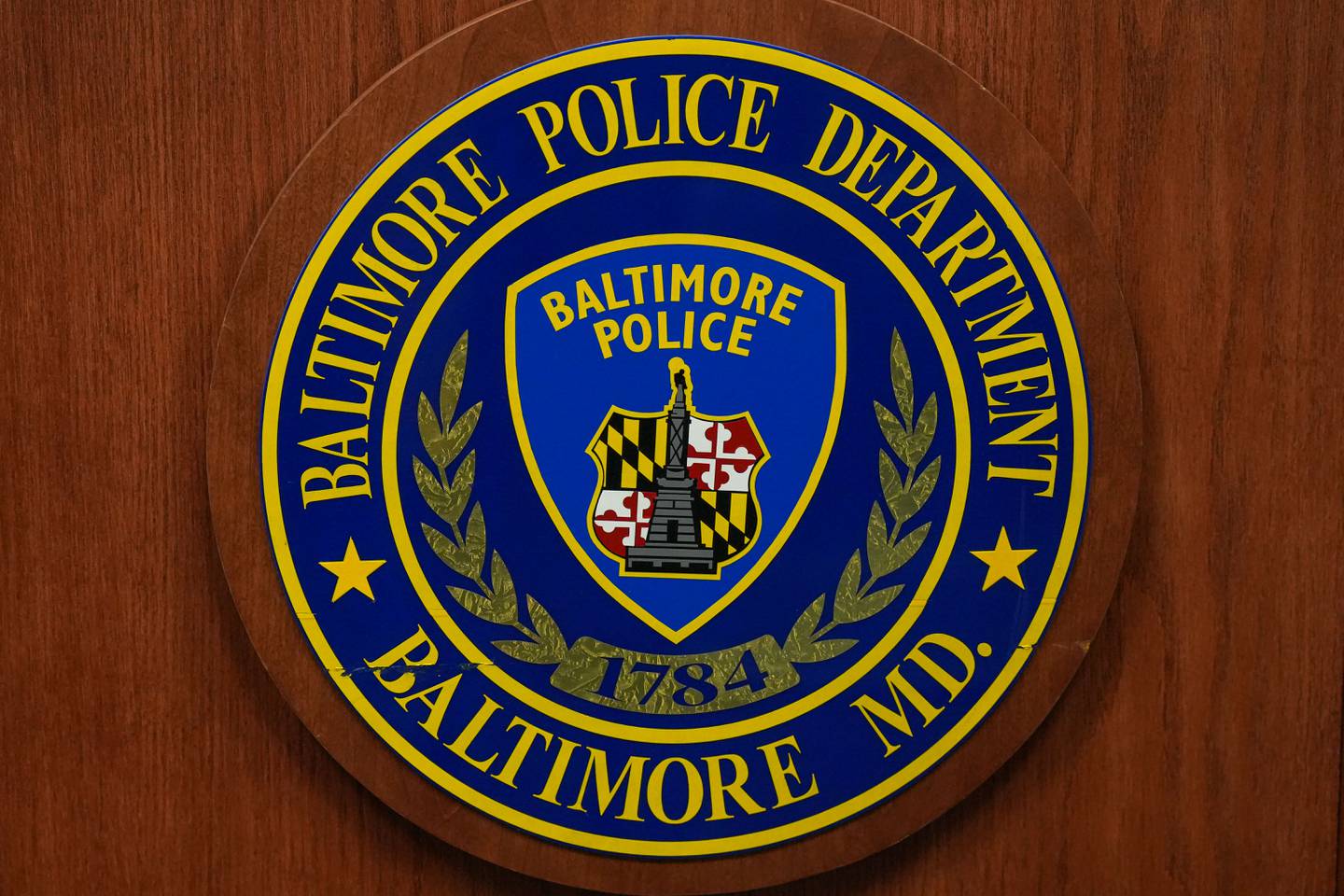 6/29/22—A detail of the Baltimore Police Department crest seen on a lectern in Baltimore City Police Headquarters.