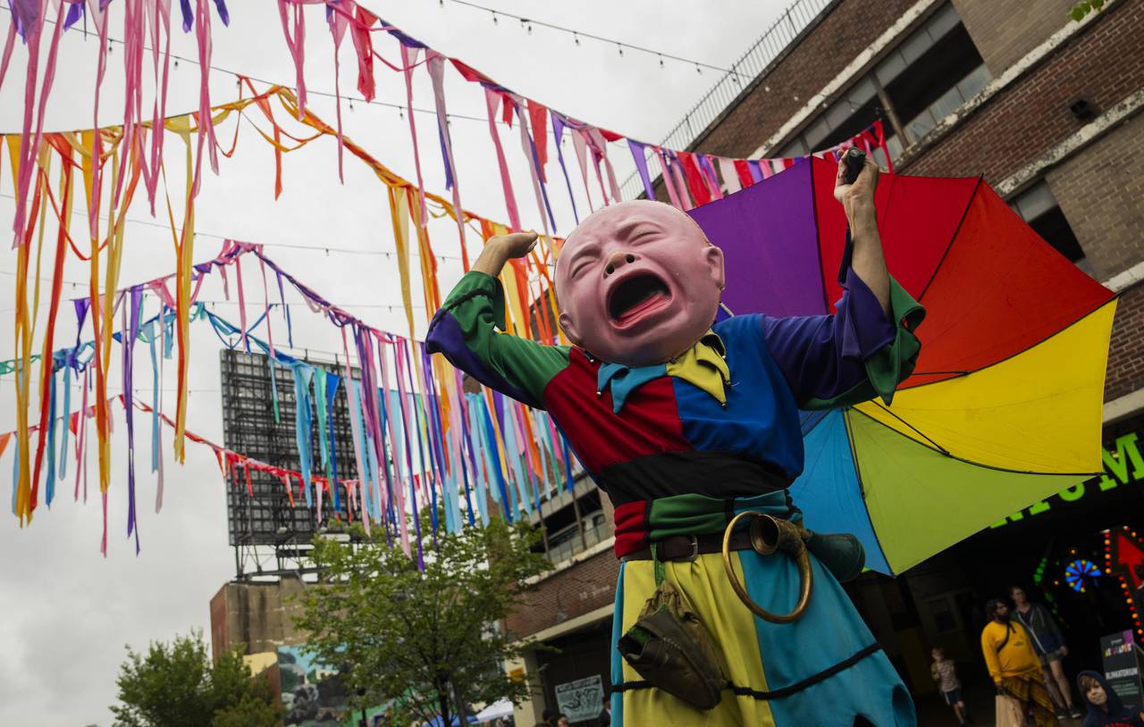 A crying baby on stilts stops to throw a temper tantrum at Artscape on September 24, 2023.