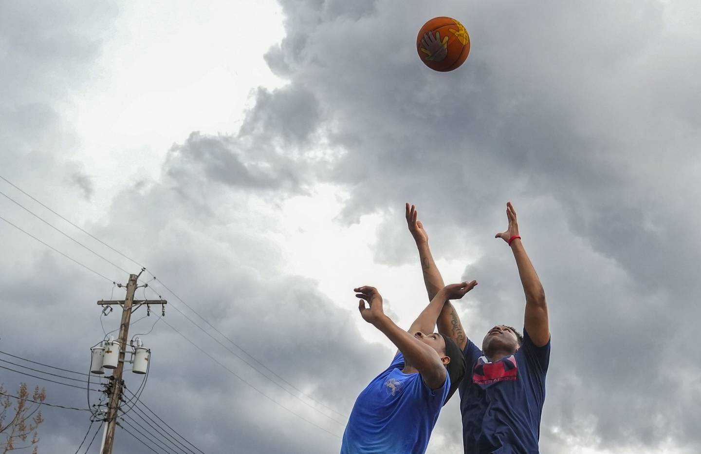 Myron Green (right) plays a game of pick-up basketball, at Tench Tilghman Basketball Court, in Baltimore, April 15, 2023.