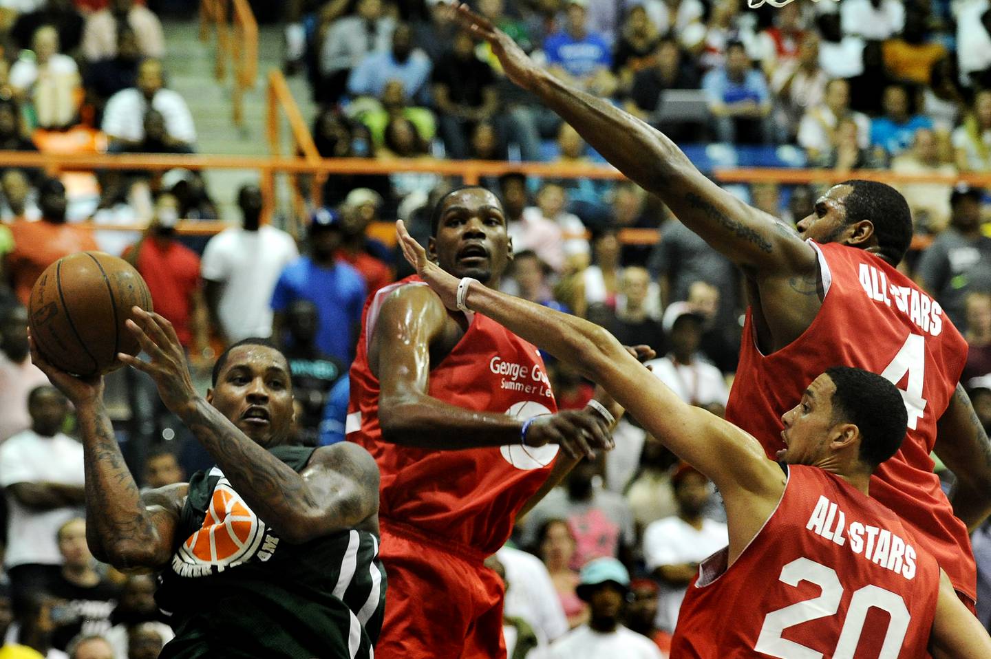 Carmelo Anthony looks for an open teammate during the Goodman League All-Stars taking on The Melo League basketball game at Edward P. Hurt Gymnasium at Morgan State University on August 30, 2011.