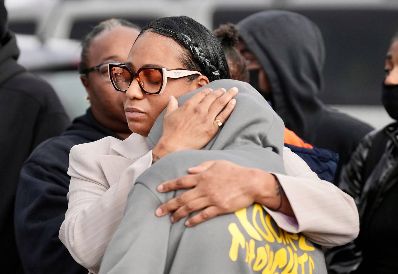 Family and friends of Deanta Dorsey, the student killed yesterday, support each other during a press conference at the Edmondson Village, site of the shooting.